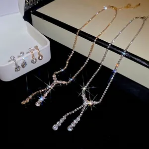 Elegant silver and gold jewelry set featuring sparkling round crystal pendants and Y-shaped fringe