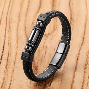 Close-up of black braided leather bracelet with black magnetic clasp and crystal beads