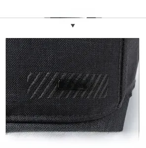 Detail of black baseball cap with side metal 'SPORT' badge and textured fabric