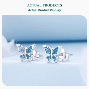 Close-up of S925 sterling silver butterfly stud earrings with blue enamel gradient finish