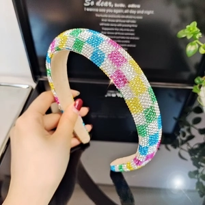 Detail of colorful rhinestone wide headband with vibrant plaid pattern and beige lining