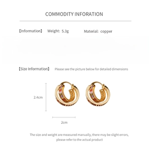 Detail view of gold cross square hoop earrings featuring colored gemstone inlays