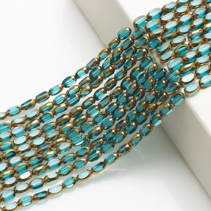 Close-up of 4x6mm turquoise and gold glass beads for DIY jewelry and necklaces