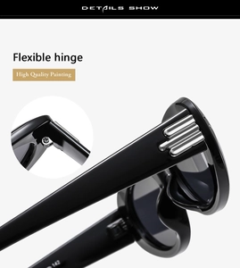 Detail of flexible metal spring hinge and silver decorative stripes on oval sunglasses
