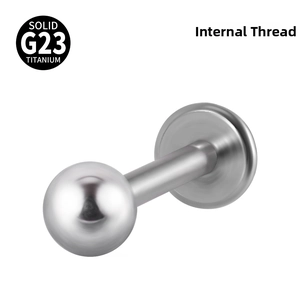 Detail of G23 titanium labret stud with internal thread and polished ball top