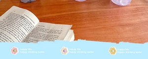 Detailed view of three cute macaron-colored floral straw cover caps for water bottles