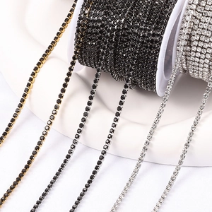 Golden and silver stainless steel rhinestone cup chains on white spools for DIY jewelry