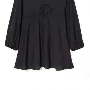 Elegant black V-neck dress featuring lace-up collar and long lantern sleeves on white background