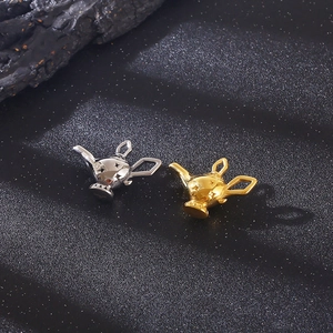 Macro view of gold and silver Aladdin lamp pendants in polished vacuum plated steel