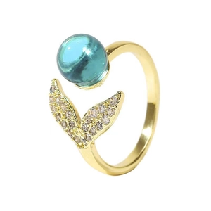 Adjustable mermaid tail ring with blue crystal bead and gold plating on white background