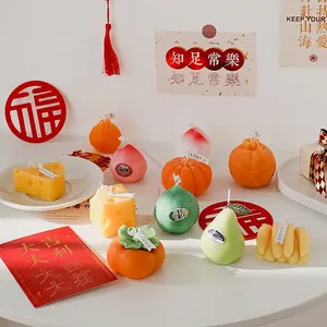 Artisanal fruit-shaped scented candles set with festive Lunar New Year decor