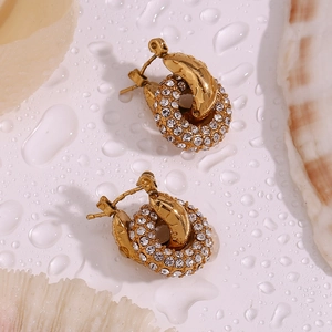 Macro detail of 18K gold plated hoop earrings with micro-inlaid rhinestones on shell