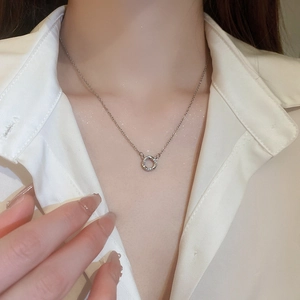 Elegant silver stainless steel circular zircon necklace for women on a white shirt