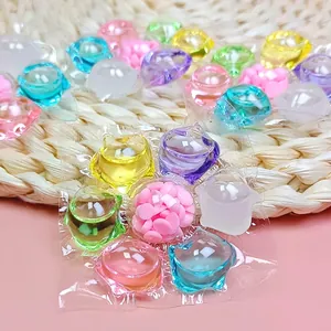 Multi-colored 5D laundry pods with scent beads on a minimalist woven background