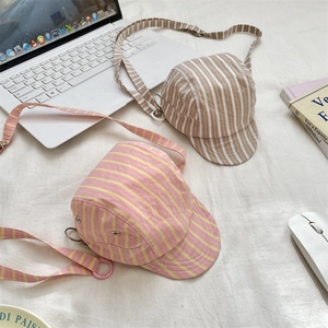 Detailed close-up of retro striped hat-shaped crossbody bags with adjustable straps