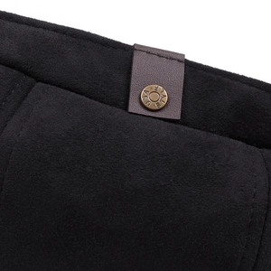 Detail of black suede newsboy hat with brown leather strap and USA STYLE button