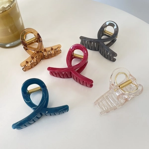 Set of five heart-shaped acetate hair claws in various candy colors on a white surface