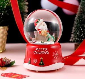 Detail of a Christmas crystal ball music box with Santa and Merry Christmas base