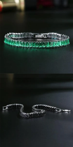 Detailed macro of rectangular emerald and black zircon gemstones on a silver-tone bracelet