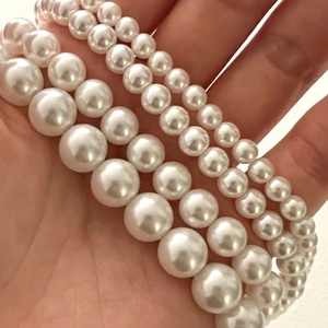 Macro shot of 925 sterling silver pearl beads showing four different sizes and luster