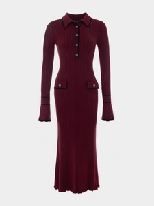 Detail of burgundy ribbed knit dress with gold buttons and black contrast trim decoration