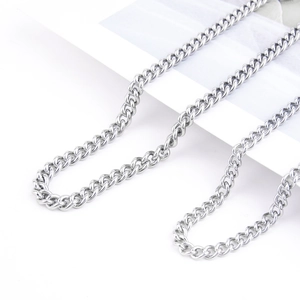Detail of silver stainless steel Cuban link necklaces showing different widths and textures