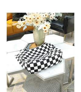 Detail of checkered canvas tote bag on a white table with a home decor background