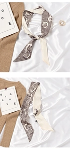 Detail of a beige silk scarf with character illustrations and a smooth satin texture