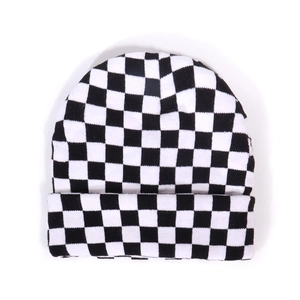 White and black checkerboard knit beanie hat with a minimalist rolled cuff design
