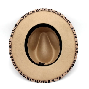Detail view of khaki fedora hat featuring leopard print pattern on the brim underside