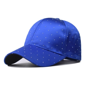 Close-up of sparkling silver rhinestones on a royal blue baseball cap for women