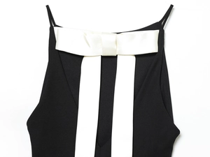 Détail d'un grand nœud en satin blanc sur un haut noir contrasté pour femme décontracté