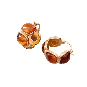 Vintage rose gold resin square earrings with amber cabochon inlay on white background