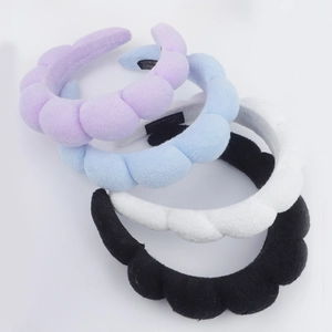 Thick sponge spa headbands in purple, blue, white, and black with soft terry fabric texture