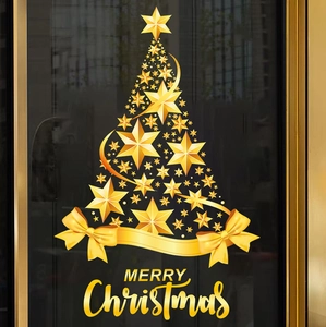 Detail of golden star Christmas tree and Merry Christmas lettering window sticker