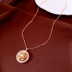 Detailed macro view of a rose gold vintage rotating flower pendant with zircon inlay