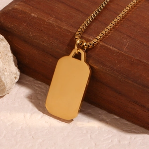 Minimalist 18K gold plated rectangular moon pendant necklace displayed on a wooden base