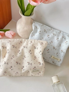 Floral print canvas makeup bags in cream and blue with elegant tulip background decoration