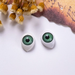 Macro shot of 12x16mm green acrylic doll eyes with realistic radial iris textures