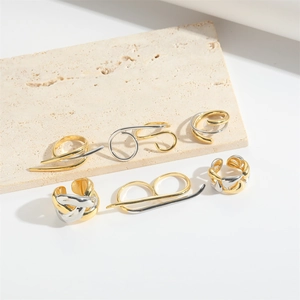 Set of 6 gold and silver abstract irregular open rings on a minimalist stone base
