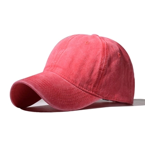 Detail of vintage washed dark red baseball cap fabric with visible stitched eyelets