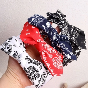Set of four paisley pattern knotted bow headbands in red, white, black, and navy blue