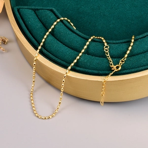 Detail of 18K gold-plated stainless steel rice bead necklace with K18 hallmark tag