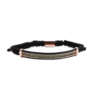 Detail of woven rope bracelet with rose gold bar and micro-pave green crystals