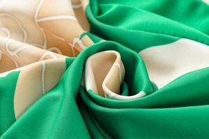 Macro detail of high-quality floral print fabric with ruffled edges and silky texture