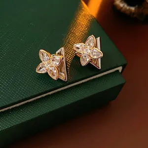 Exquisite gold clover flower stud earrings with marquise zircons in high-end design