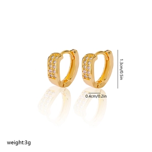 Detail shot of gold-plated copper huggie earrings with cubic zirconia and size dimensions