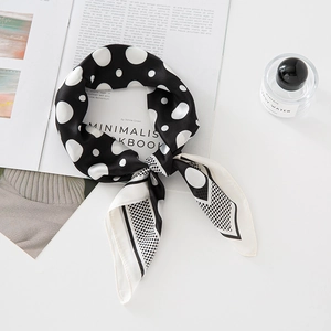 Elegant black and white polka dot silk scarf on a minimalist lookbook with perfume