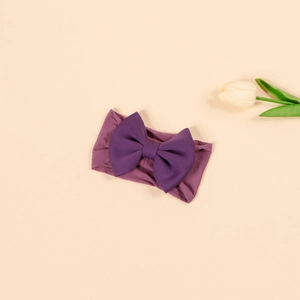 Close-up of baby nylon headband with purple 3D bow design and high-elasticity fabric