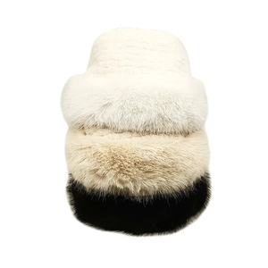 Three-color stack of plush winter bucket hats with woven crown and fluffy fur brim detail